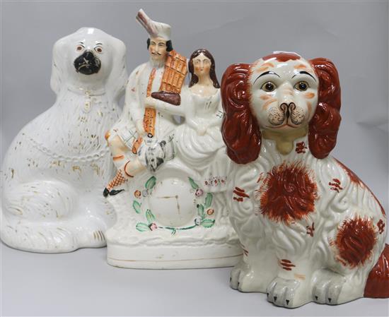 A Staffordshire figural group and two Staffordshire style dogs